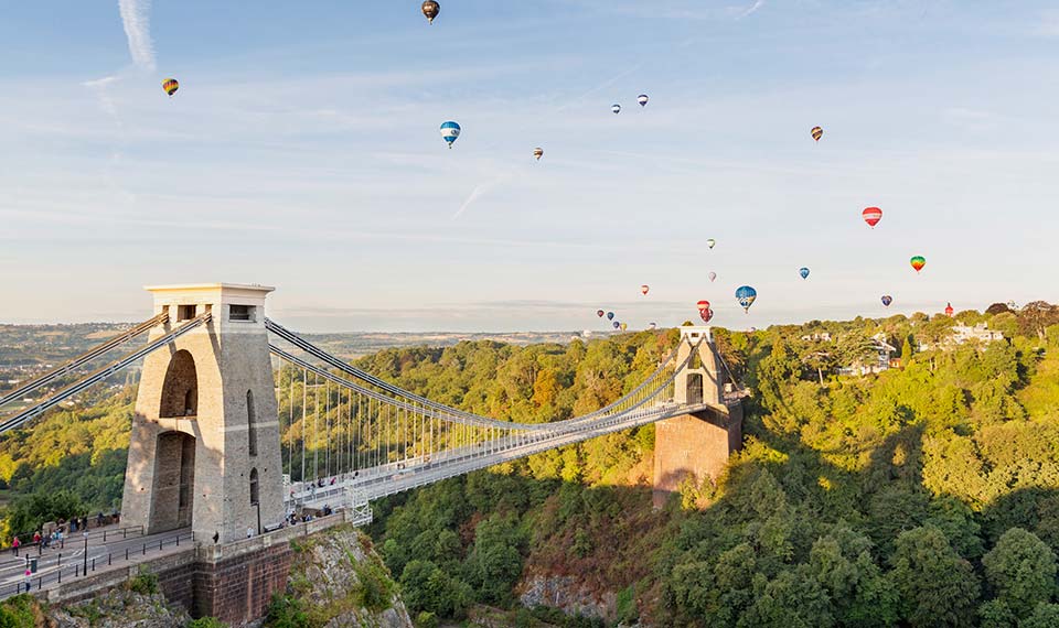 Clifton Suspension Bridge with hot air balloons in sky